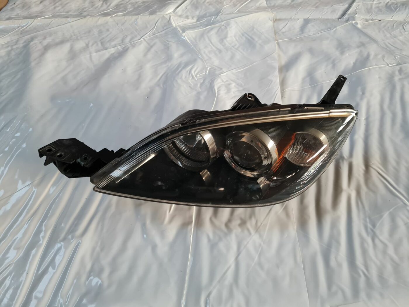 Priekšējais kreisais lukturis priekš MAZDA 3 2007 1 Priekšējais kreisais lukturis priekš MAZDA 3 2007