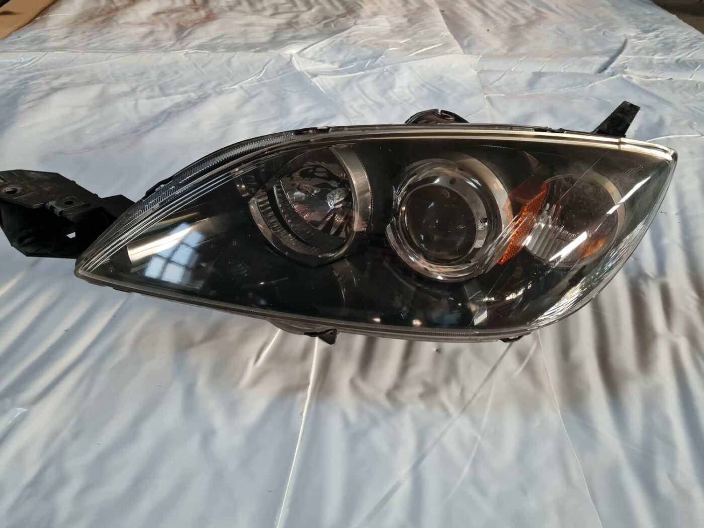 Priekšējais kreisais lukturis priekš MAZDA 3 2007 2 Priekšējais kreisais lukturis priekš MAZDA 3 2007